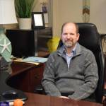 Douglas Waclawski sits at his desk in his office at Homer High School on Thursday, May 1. (Chloe Pleznac/Homer News)