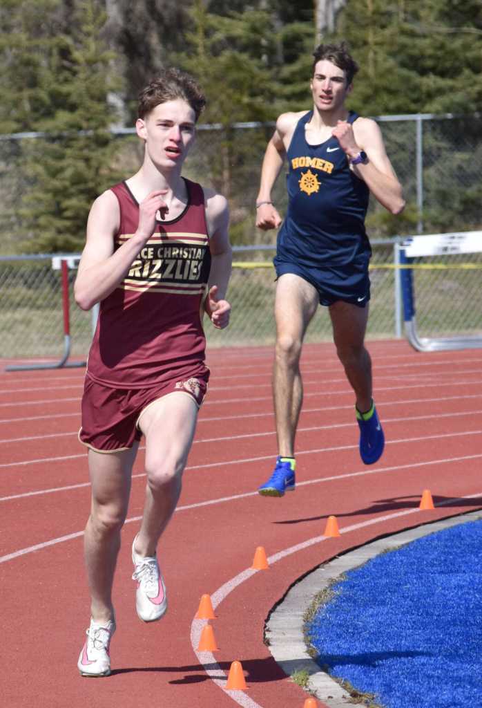 Grace Christians Robbie Annett leads Homers Johannes Bynagle on the way to victory in the 800-meter run at the SoHi Invite on Saturday, May 3, 2025, at Soldotna High School in Soldotna, Alaska. (Photo by Jeff Helminiak/Peninsula Clarion)