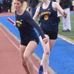 Homers Maddy Miotke takes the baton from Beatrix McDonough in the 1,600-meter relay at the SoHi Invite on Saturday, May 3, 2025, at Soldotna High School in Soldotna, Alaska. (Photo by Jeff Helminiak/Peninsula Clarion)