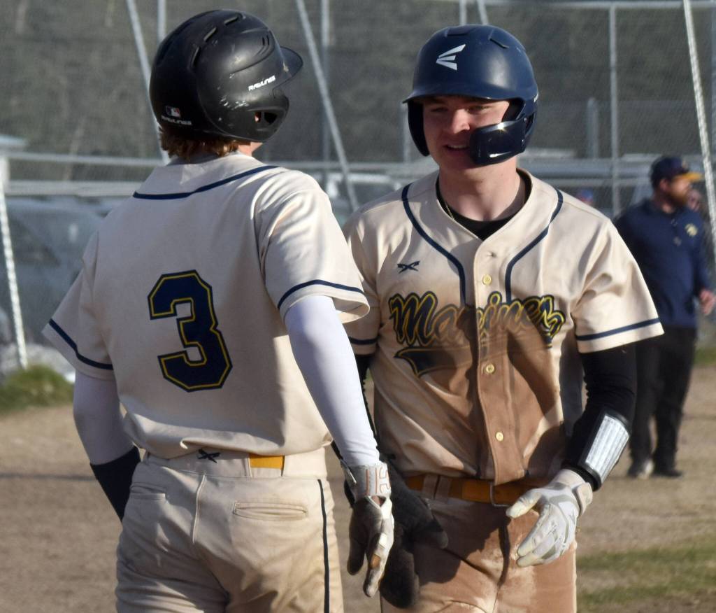 Homers Weston Marley (3) and Preston Stanislaw celebrate a bases-clearing double against Kenai Central on Friday, May 9, 2025, at the Kenai Little League fields in Kenai, Alaska. (Photo by Jeff Helminiak/Peninsula Clarion)
