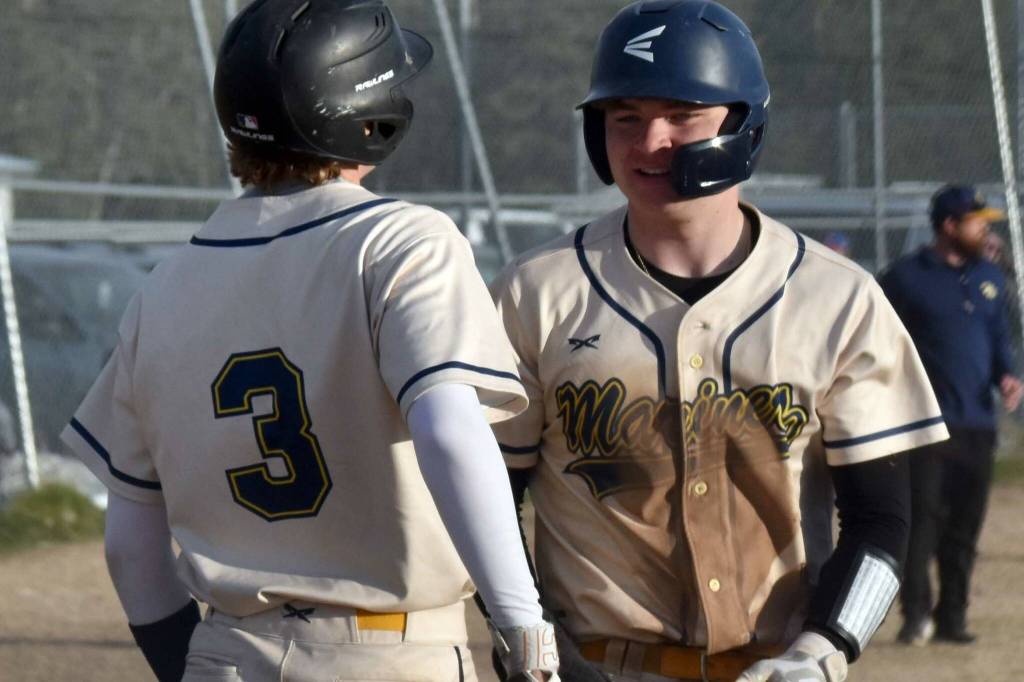 Homer's Weston Marley (3) and Preston Stanislaw celebrate a bases-clearing double against Kenai Central on Friday, May 9, 2025, at the Kenai Little League fields in Kenai, Alaska. (Photo by Jeff Helminiak/Peninsula Clarion)
