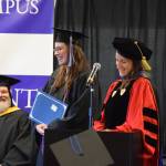Dr. Lia Calhoun (right), Kachemak Bay Campus Associate Professor of English and Communications, presents Semester By the Bay student Javin Schroeder (center) with this years Student Faculty and Staff Choice Award at the 55th annual commencement ceremony on Wednesday, May 7, 2025, at Kachemak Bay Campus in Homer, Alaska. (Delcenia Cosman/Homer News)
