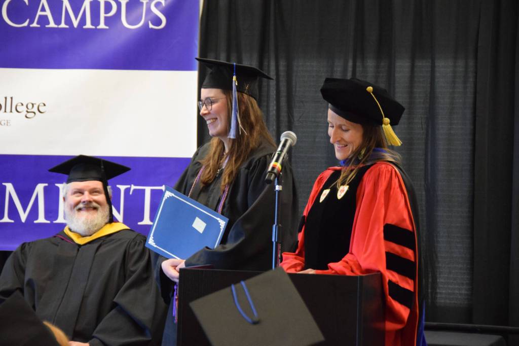 Dr. Lia Calhoun (right), Kachemak Bay Campus Associate Professor of English and Communications, presents Semester By the Bay student Javin Schroeder (center) with this years Student Faculty and Staff Choice Award at the 55th annual commencement ceremony on Wednesday, May 7, 2025, at Kachemak Bay Campus in Homer, Alaska. (Delcenia Cosman/Homer News)