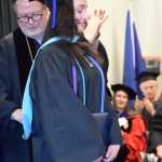 Homer News reporter Chloe Pleznac receives her hood for her Masters in Public Administration degree at the 55th annual commencement ceremony on Wednesday, May 7, 2025, at Kachemak Bay Campus in Homer, Alaska. (Delcenia Cosman/Homer News)
