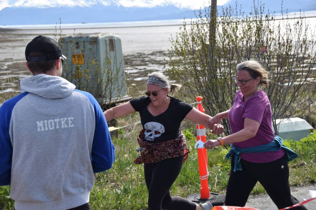 Claudia Haines and Amy Russell playfully tussle as they cross the finish line during the 2025 Migration Run on Mothers Day, Sunday, May 11 on the Homer Spit in Homer, Alaska. (Chloe Pleznac/Homer News)