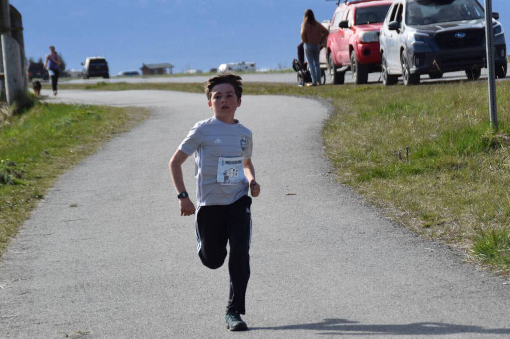 10-year-old Renn Marden of Seward closes in on the finish line Sunday, May 11 during the 2025 Migration Run on Mothers Day, Sunday, May 11 on the Homer Spit in Homer, Alaska. Marden finished with a time of 24:52.09, securing his 8th place out of 26 other male finishers. (Chloe Pleznac/Homer News)