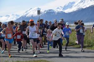 Runners set off from the starting line at the beginning of the 2025 Migration Run on Mothers Day, Sunday, May 11 on the Homer Spit in Homer, Alaska. (Chloe Pleznac/Homer News)