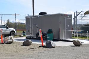 The new, mobile bathroom unit rests on a concrete slab at Jack Gist Park on Tuesday, May 13, 2025 in Homer, Alaska. (Chloe Pleznac/Homer News)