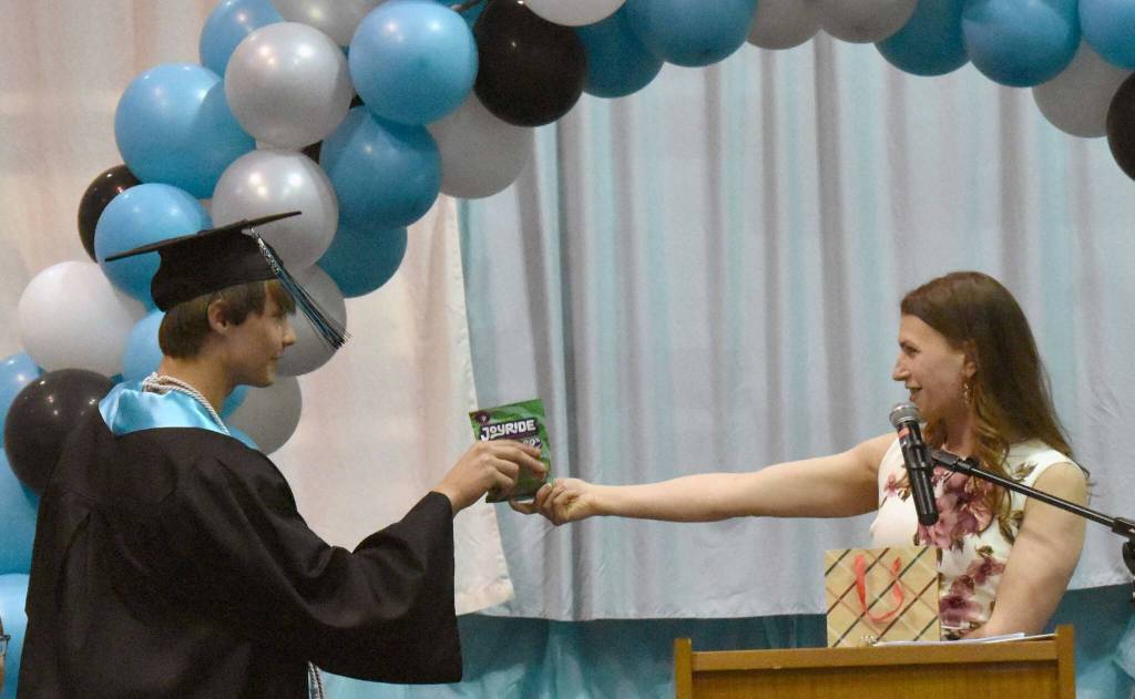 Guest speaker Donica Nash gave out candy matching each student, including this package of JOYRIDE to Gideon Pankratz, at the River City Academy graduation ceremony Tuesday, May 20, 2025, at Skyview Middle School just outside of Soldotna, Alaska. (Photo by Jeff Helminiak/Peninsula Clarion)