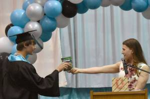 Guest speaker Donica Nash gave out candy matching each student, including this package of JOYRIDE to Gideon Pankratz, at the River City Academy graduation ceremony Tuesday, May 20, 2025, at Skyview Middle School just outside of Soldotna, Alaska. (Photo by Jeff Helminiak/Peninsula Clarion)