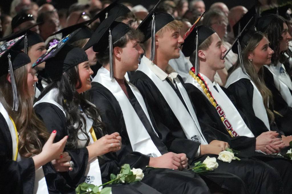 Nikiski graduates view their slideshow during a commencement ceremony at Nikiski/Middle High School in Nikiski, Alaska, on Monday, May 19, 2025. (Jake Dye/Peninsula Clarion)