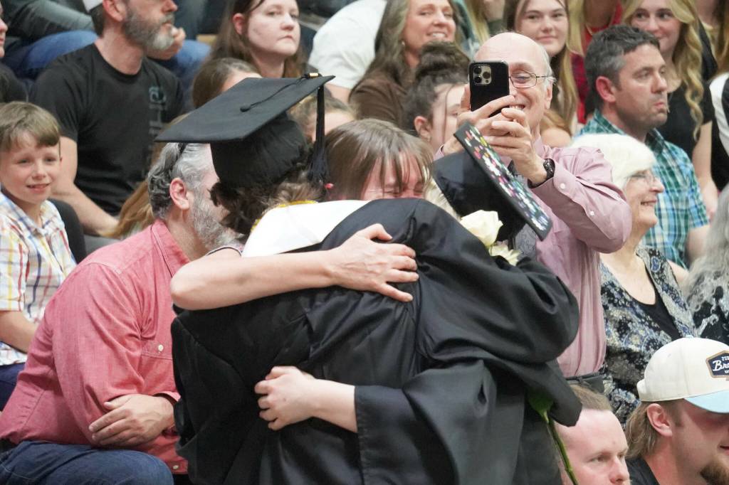 Nikiski graduates bring roses to one of their supporters, teacher Carla Jenness, during a commencement ceremony at Nikiski/Middle High School in Nikiski, Alaska, on Monday, May 19, 2025. (Jake Dye/Peninsula Clarion)