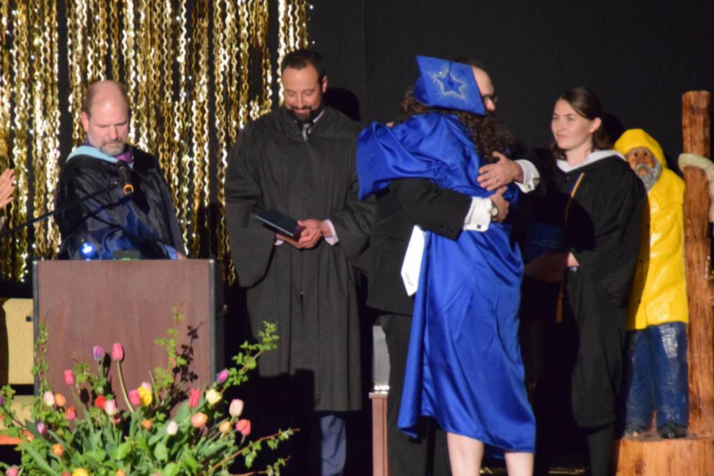 Graduating senior Rainey Sundheim hugs choral director Kyle Schneider as he presents her with her diploma during the 2025 Homer High School graduation ceremony on Wednesday, May 21, 2025, in the Alice Witte Gymnasium. (Chloe Pleznac/Homer News)