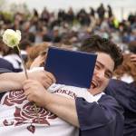 Graduates of Soldotna High School celebrate after receiving their diplomas on the schools football field in Soldotna, Alaska, on Wednesday, May 21, 2025. (Jake Dye/Peninsula Clarion)