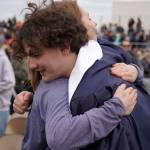 Elias Bouschor, a graduates of Soldotna High School, celebrates after receiving his diploma on the schools football field in Soldotna, Alaska, on Wednesday, May 21, 2025. (Jake Dye/Peninsula Clarion)