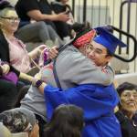 Kenai Alternative High School graduates embrace supporters during their commencement ceremony in the schools gym in Kenai, Alaska, on Wednesday, May 22, 2025. (Jake Dye/Peninsula Clarion)