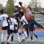 Soldotna defender Daniel Heath and goalie Luke Hillyer sky through the air to keep the ball out of the net Thursday, May 22, 2025, at Justin Maile Field at Soldotna High School in Soldotna, Alaska. (Photo by Jeff Helminiak/Peninsula Clarion)