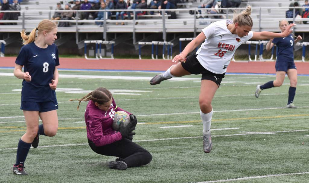 Soldotna goalie Ryan Queen makes a save in front of Soldotna defender Keely Sundberg and Kenai Central forward Katie Johnson on Thursday, May 22, 2025, at Justin Maile Field at Soldotna High School in Soldotna, Alaska. (Photo by Jeff Helminiak/Peninsula Clarion)