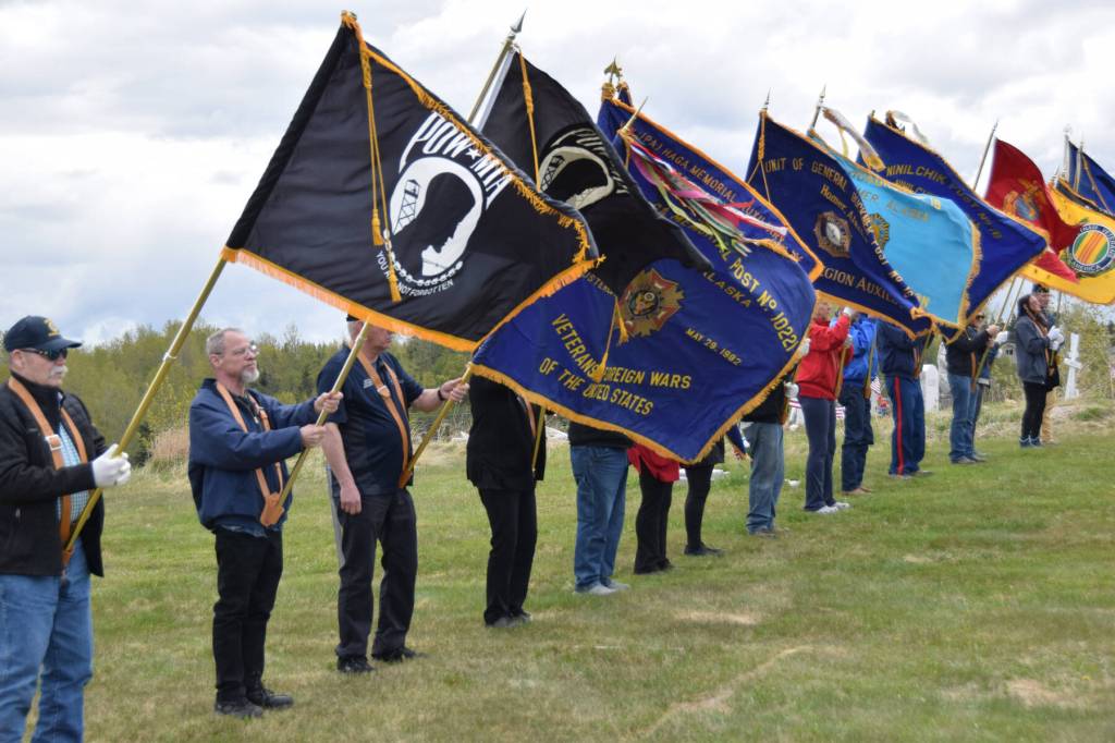Color guard flags wave in the wind at the American Legion Cemetery in Ninilchik, Alaska during a Memorial Day ceremony on Monday, May 26, 2025. (Delcenia Cosman/Homer News)
