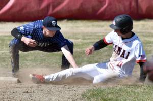 Soldotna second baseman Brett Hostetler tags out Kenai Central's Braden Smith on Saturday, May 10, 2025, at the Kenai Little League fields in Kenai, Alaska. (Photo by Jeff Helminiak/Peninsula Clarion)