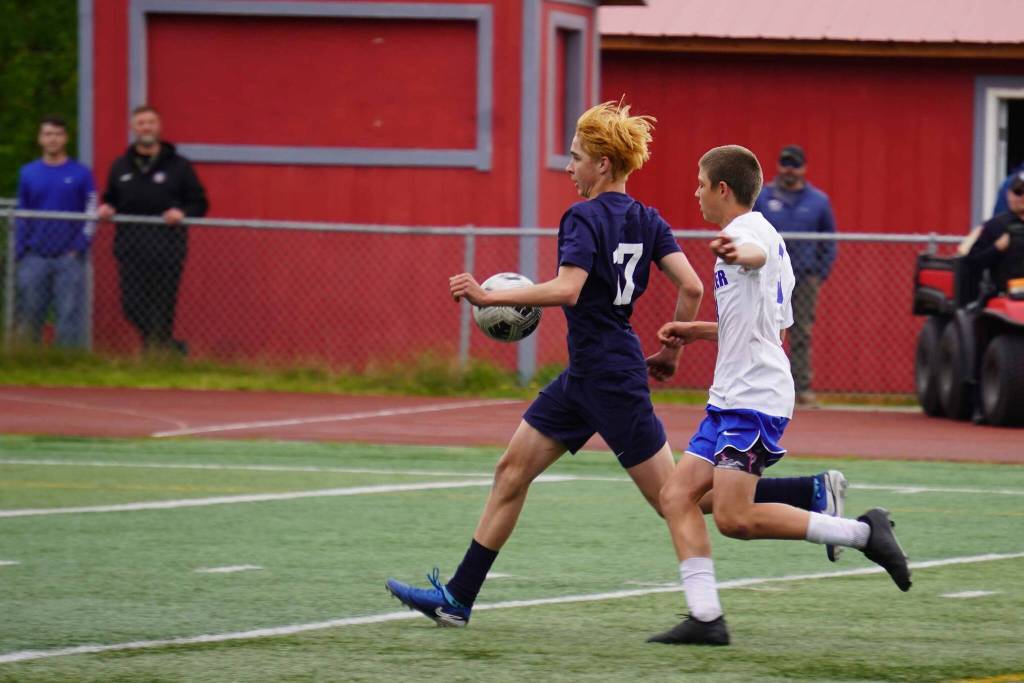 Soldotnas Simon Willets outpaces Palmers Hunter Browning on his way to kick a goal to tie up the game during the final match of the ASAA Division II Boys Soccer Championship at Wasilla High School in Wasilla, Alaska, on Saturday, May 31, 2025. (Jake Dye/Peninsula Clarion)