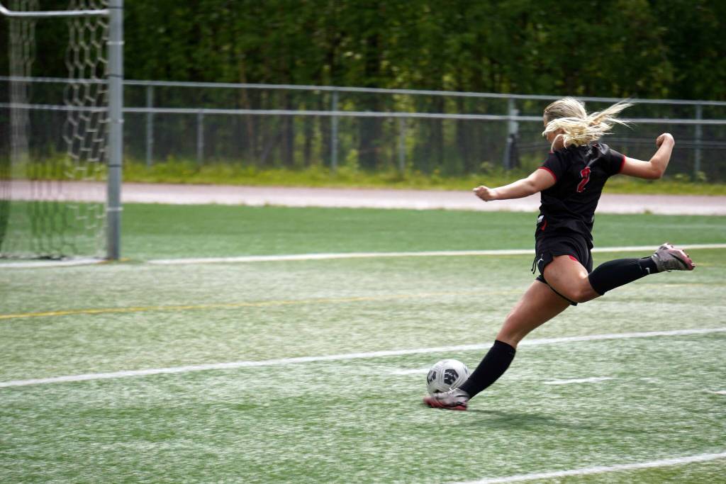 Kenais Brynnen Hanson winds up for a shot during the final match of the ASAA Division II Girls Soccer Championship at Wasilla High School in Wasilla, Alaska, on Saturday, May 31, 2025. (Jake Dye/Peninsula Clarion)