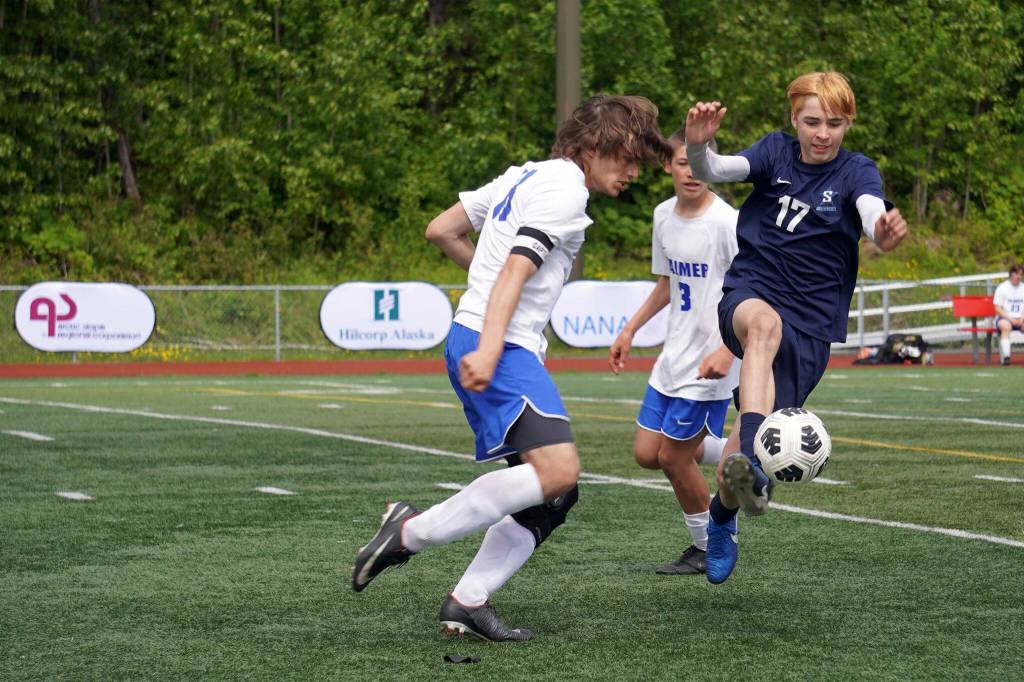 Soldotnas Lane Hillyer moves with the ball against opposition by Palmers Jacob Logan during the final match of the ASAA Division II Boys Soccer Championship at Wasilla High School in Wasilla, Alaska, on Saturday, May 31, 2025. (Jake Dye/Peninsula Clarion)