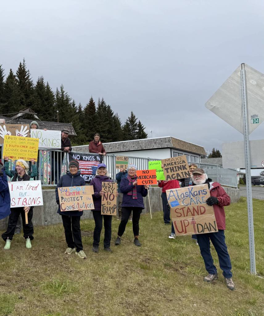Demonstrators stand on the corner of Pioneer Avenue and Svedlund Street in Homer, Alaska on Friday, May 30. They hoped to catch Senator Sullivans attention as he drove by to attend a private meeting at the Homer Senior Citizens Center.