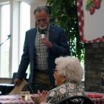 Kenai Peninsula Borough Mayor Peter Micciche presents a commendation to Hanna Stormo during her 102nd birthday party at Aspen Creek Senior Living in Soldotna, Alaska, on Friday, May 30, 2025. (Jake Dye/Peninsula Clarion)