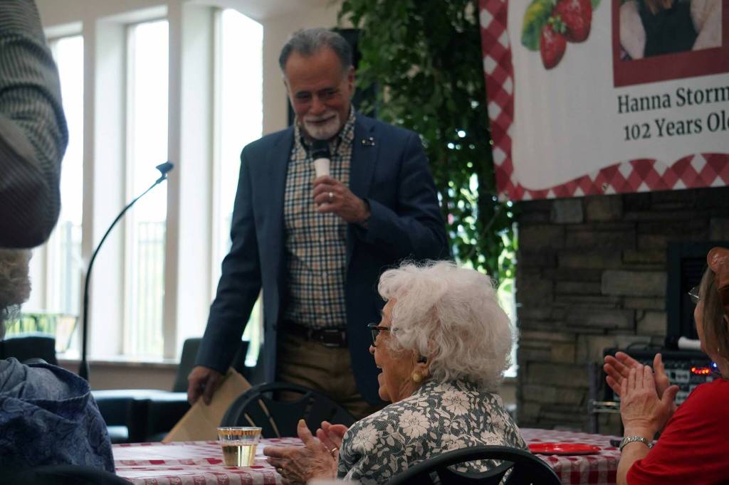 Kenai Peninsula Borough Mayor Peter Micciche presents a commendation to Hanna Stormo during her 102nd birthday party at Aspen Creek Senior Living in Soldotna, Alaska, on Friday, May 30, 2025. (Jake Dye/Peninsula Clarion)