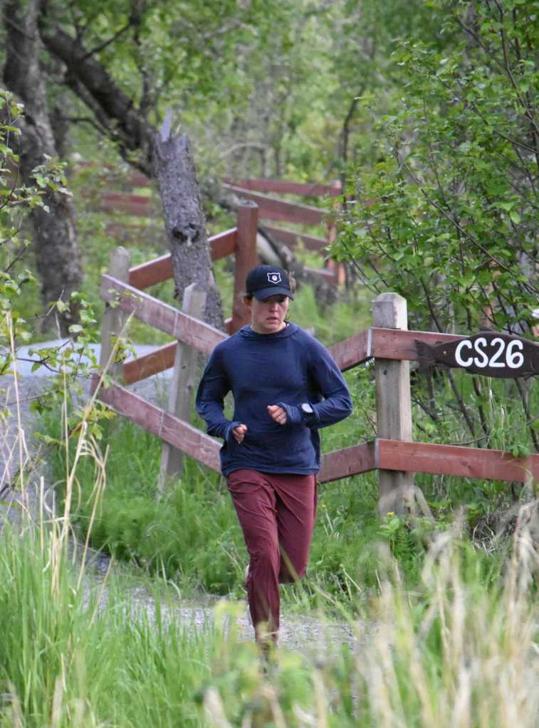 Julianne Dickerson of Anchorage runs along the Kenai River at the Tsalteshi Backyard Ultra on Friday, June 6, 2025, in Soldotna, Alaska. (Photo by Jeff Helminiak/Peninsula Clarion)