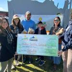 The Cutting Edge Crew, including Jonathan Bloch, Maria Bloch, Nathan Kincaid, Misty Kincaid and Nicole Reynolds, donate their first place prize of $500 to Homer Little League during the Homer Steps Up celebration on June 5, 2025, in Homer, Alaska. Photo provided by South Peninsula Hospital