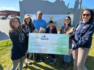 The Cutting Edge Crew, including Jonathan Bloch, Maria Bloch, Nathan Kincaid, Misty Kincaid and Nicole Reynolds, donate their first place prize of $500 to Homer Little League during the Homer Steps Up celebration on June 5, 2025, in Homer, Alaska. Photo provided by South Peninsula Hospital