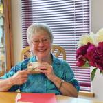 Woman of Wisdom Roberta Highland holds her award from South Peninsula Haven House in this photo taken July 25, 2020, in Homer, Alaska. (Photo courtesy South Peninsula Haven House)