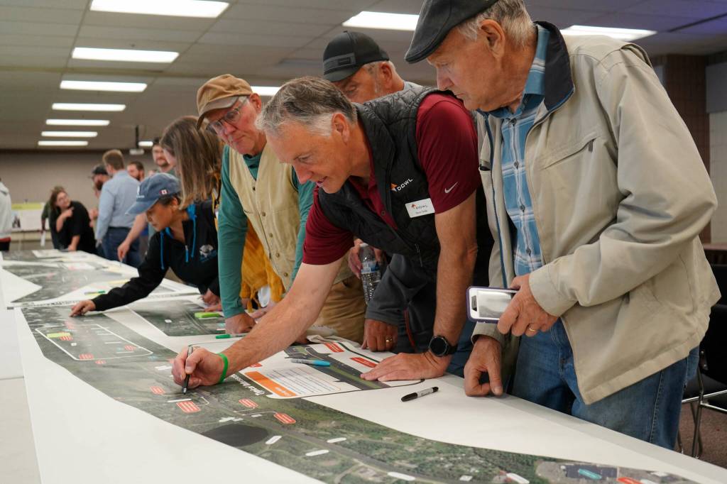 Leads for the Sterling Safety Corridor Improvements Project field questions and showcase their preferred design during an open house meeting at the Soldotna Regional Sports Complex in Soldotna, Alaska, on Tuesday, June 10, 2025. (Jake Dye/Peninsula Clarion)