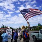 People carrying flags and signs line the Sterling Highway for a No Kings protest in Soldotna, Alaska, on Saturday, June 14, 2025. (Jake Dye/Peninsula Clarion)