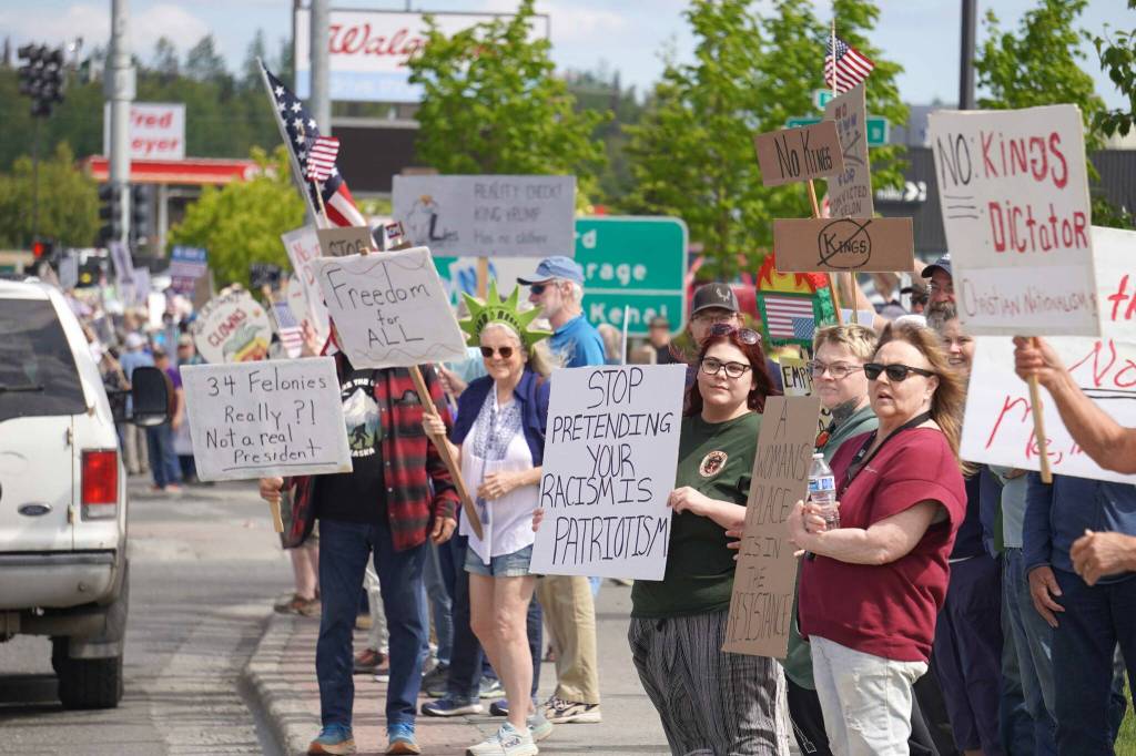 People carrying flags and signs line the Sterling Highway for a No Kings protest in Soldotna, Alaska, on Saturday, June 14, 2025. (Jake Dye/Peninsula Clarion)