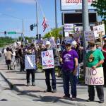 People carrying flags and signs line the Sterling Highway for a No Kings protest in Soldotna, Alaska, on Saturday, June 14, 2025. (Jake Dye/Peninsula Clarion)