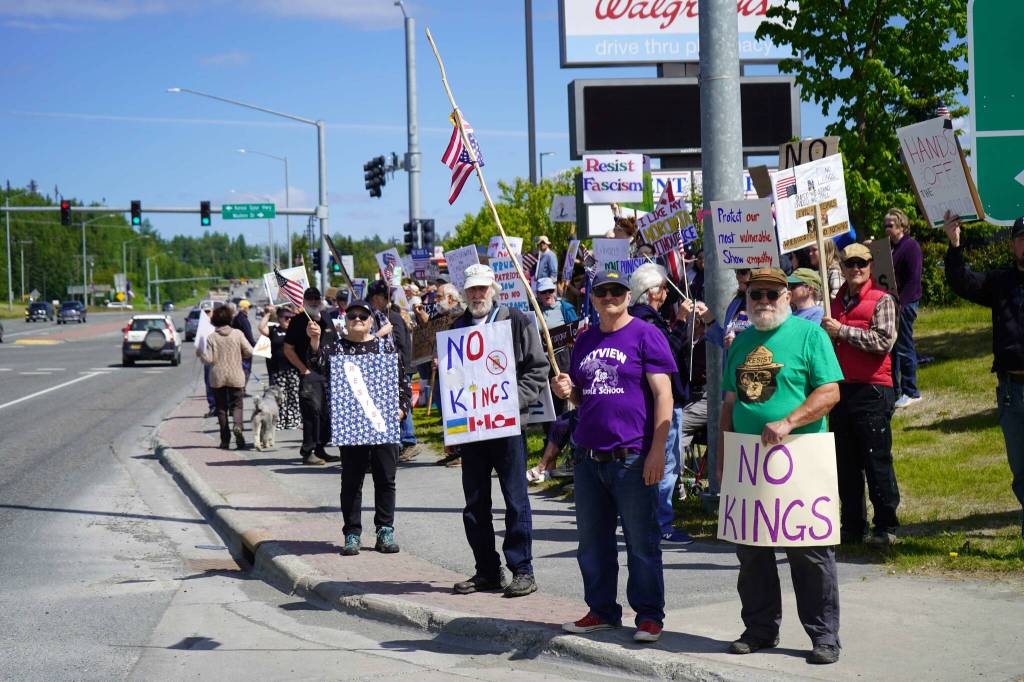 People carrying flags and signs line the Sterling Highway for a No Kings protest in Soldotna, Alaska, on Saturday, June 14, 2025. (Jake Dye/Peninsula Clarion)