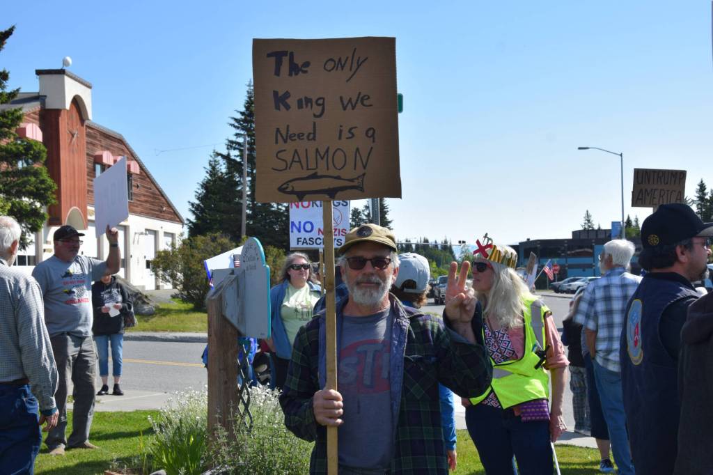 A demonstrator holds up a sign during the No Kings protest on Saturday, June 14, 2025, at WKFL Park in Homer, Alaska. (Chloe Pleznac/Homer News)