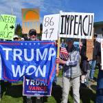 Demonstrators hold up signs on a crowded street corner during the No Kings protest on Saturday, June 14, 2025, at WKFL Park in Homer, Alaska. (Chloe Pleznac/Homer News)
