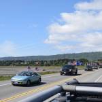 Cars and trucks adorned with flags drive down the Homer Spit Road on Saturday, June 14, 2025 in Homer, Alaska. The processional was in honor of Flag Day and the 250th anniversary of the U.S. Army being formed. (Chloe Pleznac/Homer News)