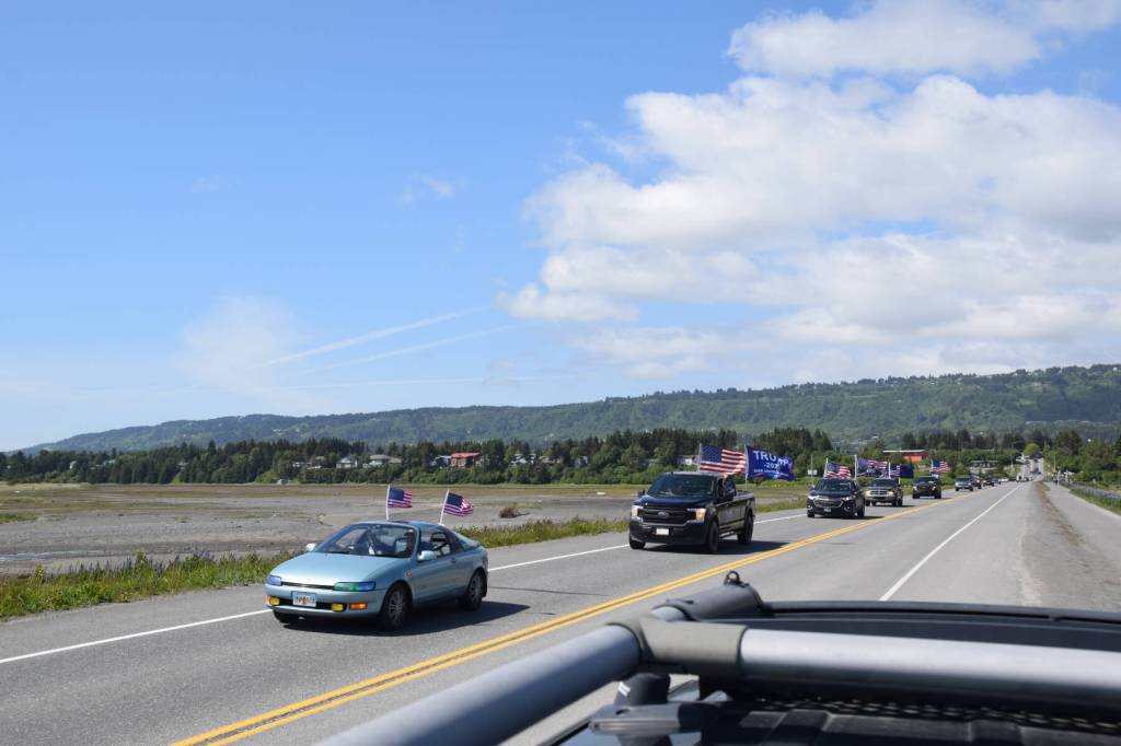 Cars and trucks adorned with flags drive down the Homer Spit Road on Saturday, June 14, 2025 in Homer, Alaska. The processional was in honor of Flag Day and the 250th anniversary of the U.S. Army being formed. (Chloe Pleznac/Homer News)