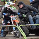 Jesse Kelly of Soldotna talks with his son, Conner Kelly, before the 50 intermediate race at the Alaska State Motocross Series Race 4 on Sunday, June 15, 2025, at Twin City Raceway in Kenai, Alaska. (Photo by Jeff Helminiak/Peninsula Clarion)