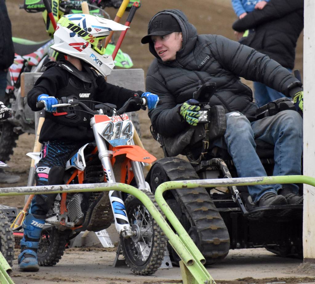 Jesse Kelly of Soldotna talks with his son, Conner Kelly, before the 50 intermediate race at the Alaska State Motocross Series Race 4 on Sunday, June 15, 2025, at Twin City Raceway in Kenai, Alaska. (Photo by Jeff Helminiak/Peninsula Clarion)