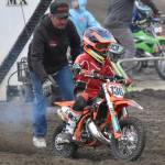 Rick Bailey of Ninilchik helps his grandson, Clydon Meyer, get started in 50 novice at the Alaska State Motocross Series Race 4 on Sunday, June 15, 2025, at Twin City Raceway in Kenai, Alaska. (Photo by Jeff Helminiak/Peninsula Clarion)