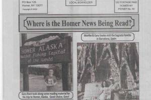 The Homer News, a small print publication based in Cortland County, New York, features photos on the back page of readers who travel with copies of the newspaper. This issue of The Homer News shows Gary Root visiting Homer, Alaska and posing for a photo with the New York paper under the "Homer Alaska, Halibut Fishing Capital of the World" sign at the top of Baycrest Hill. Photo courtesy of Kim L. Hubbard