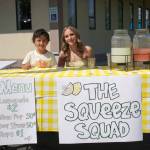 Brooklyn Coleman, right, staffs The Squeeze Squad lemonade stand during Lemonade Day in Soldotna, Alaska, on Saturday, June 14, 2025. (Jake Dye/Peninsula Clarion)