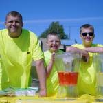 Brayden, Jackson and Bradley Gage staff the Lighting Lemon lemonade stand in Kenai, Alaska, on Saturday, June 14, 2025. (Jake Dye/Peninsula Clarion)