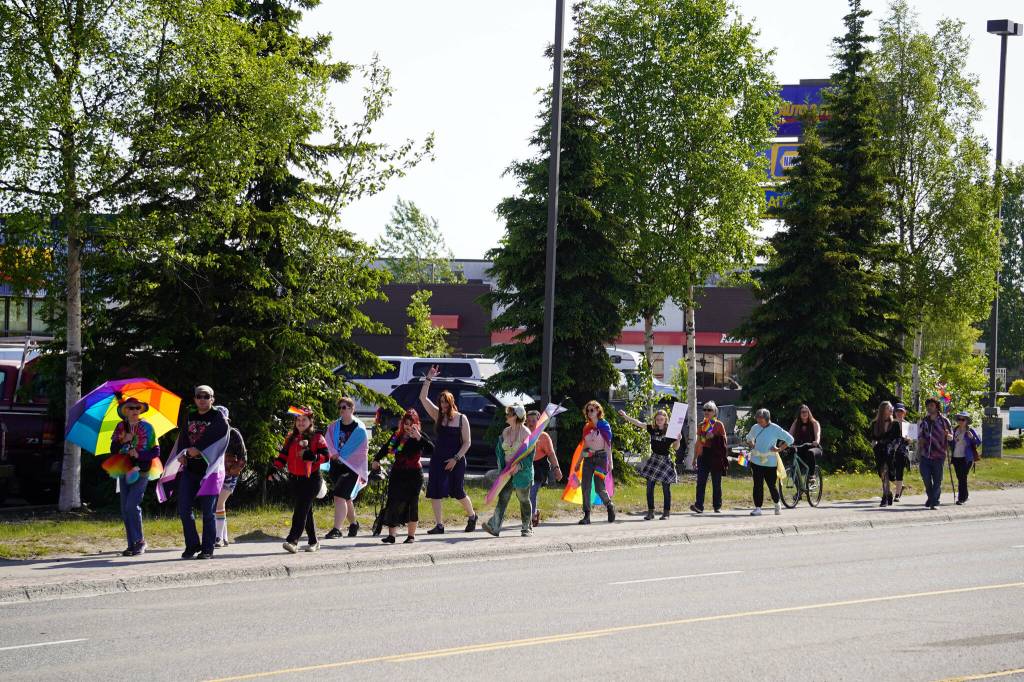A Pride march moves along the Sterling Highway through Soldotna, Alaska, on Saturday, June 24, 2025. (Jake Dye/Peninsula Clarion)